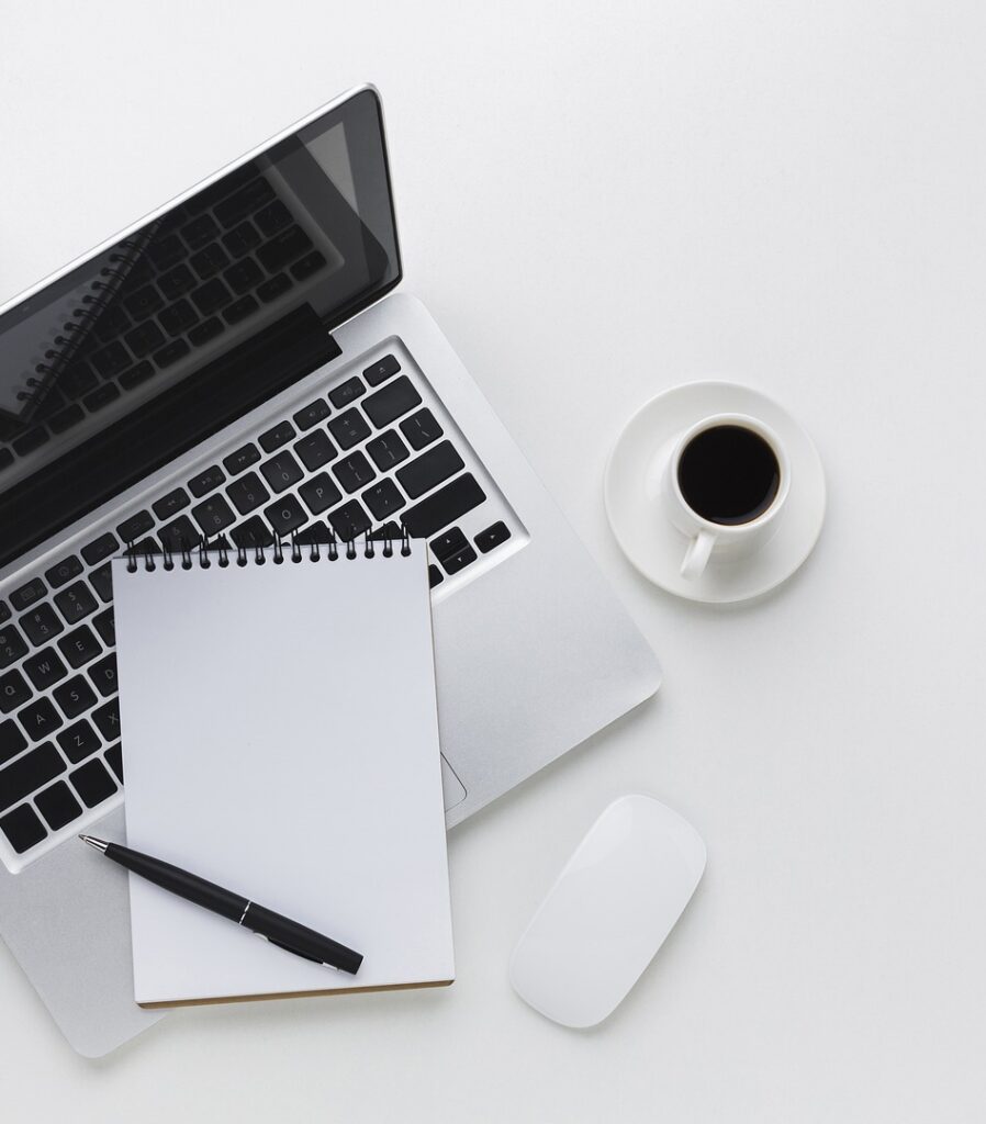 Organized desk with laptop, phone, and notebook – symbolizing efficient remote work clinical research