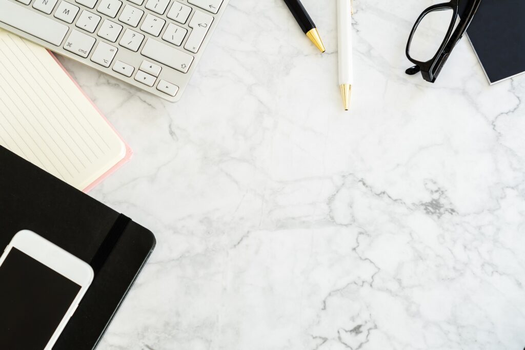 Organized desk with laptop, phone, and notebook – symbolizing efficient remote work clinical research
