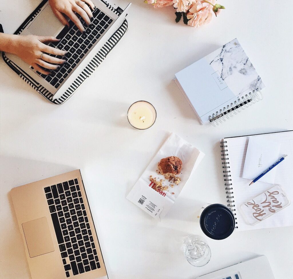 Organized desk with laptop, phone, and notebook – symbolizing efficient remote work clinical research